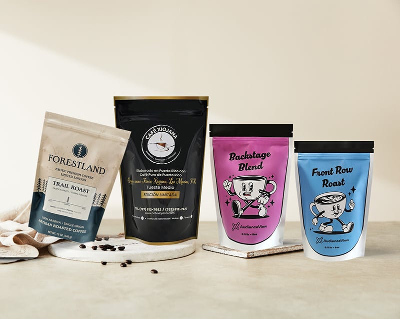 Four custom printed stand-up coffee pouches displayed on a neutral background