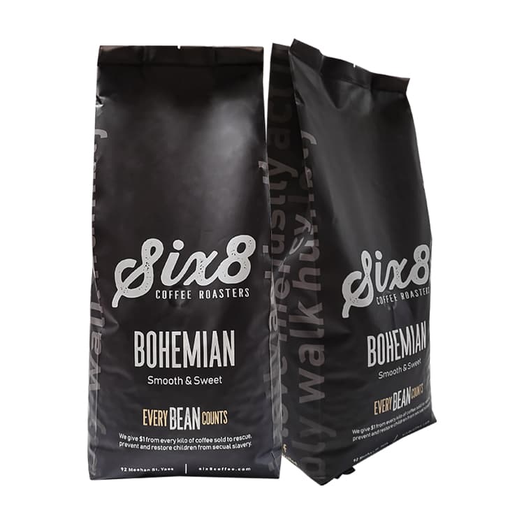 Black side gusset coffee bags shown from front and side with typography continuing onto the gusset