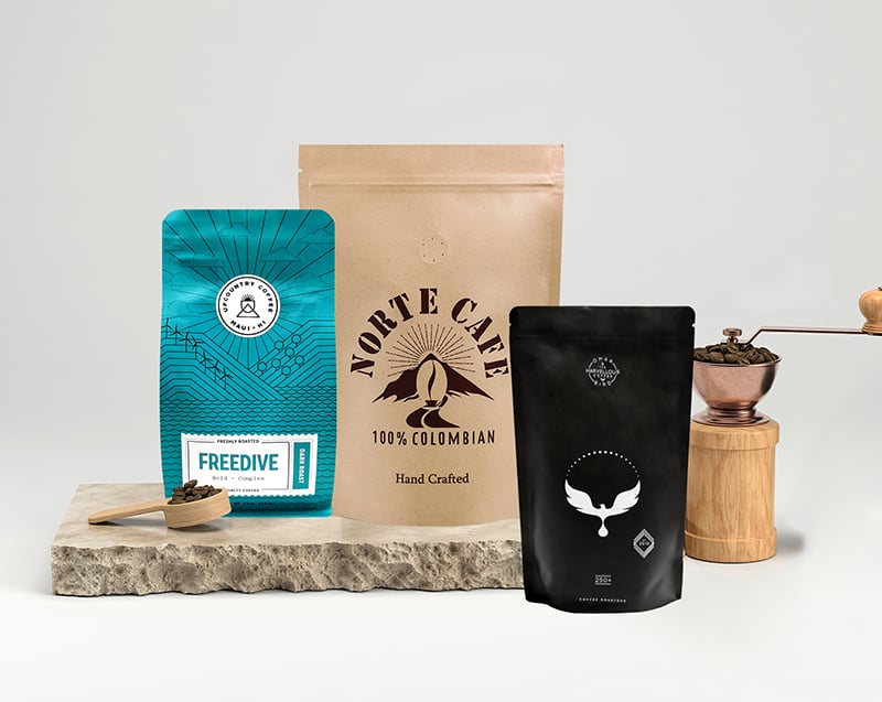 Compostable coffee bag projects displayed with coffee equipment