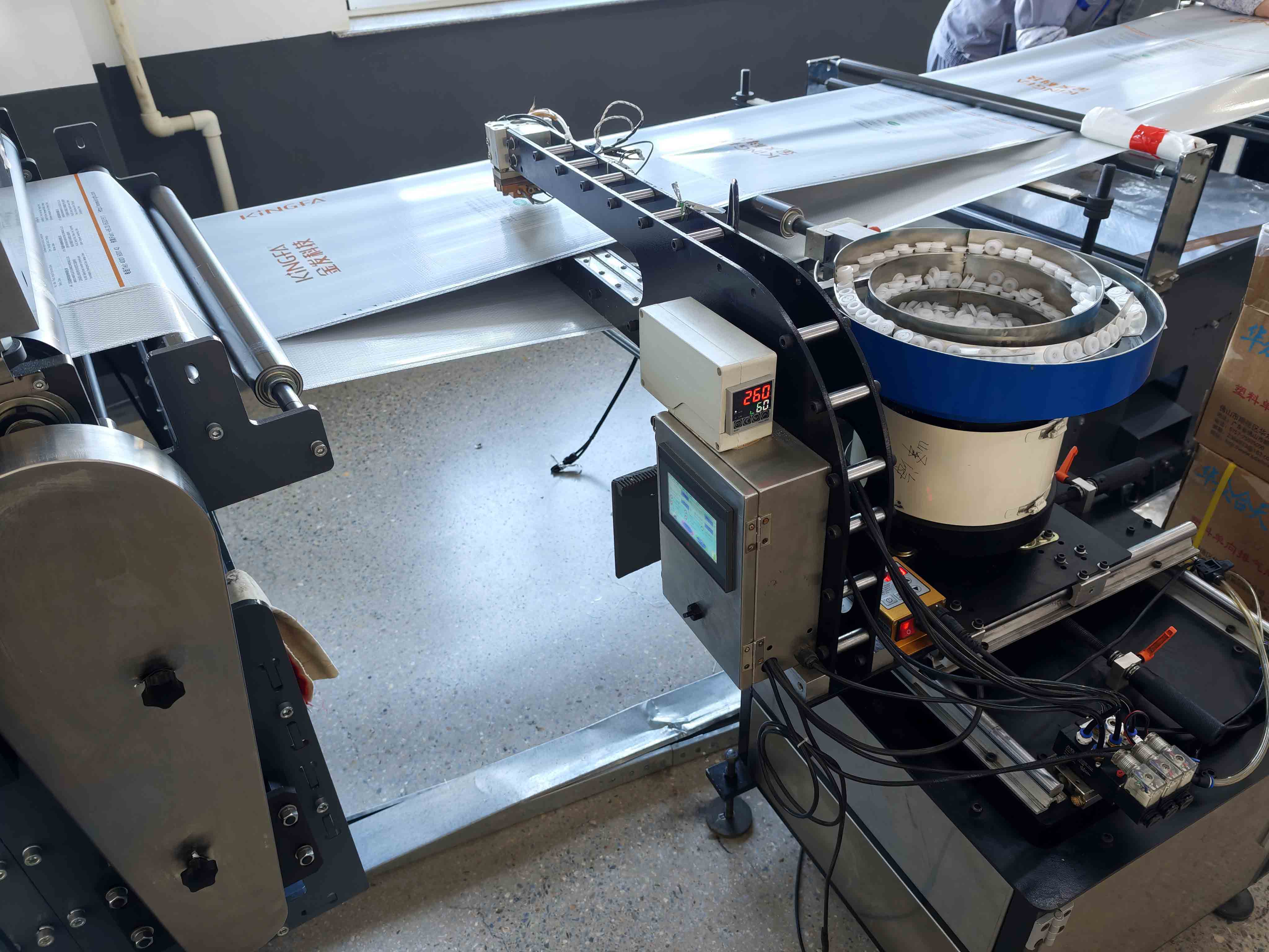 Degassing valve applicator beside printed flexible packaging film
