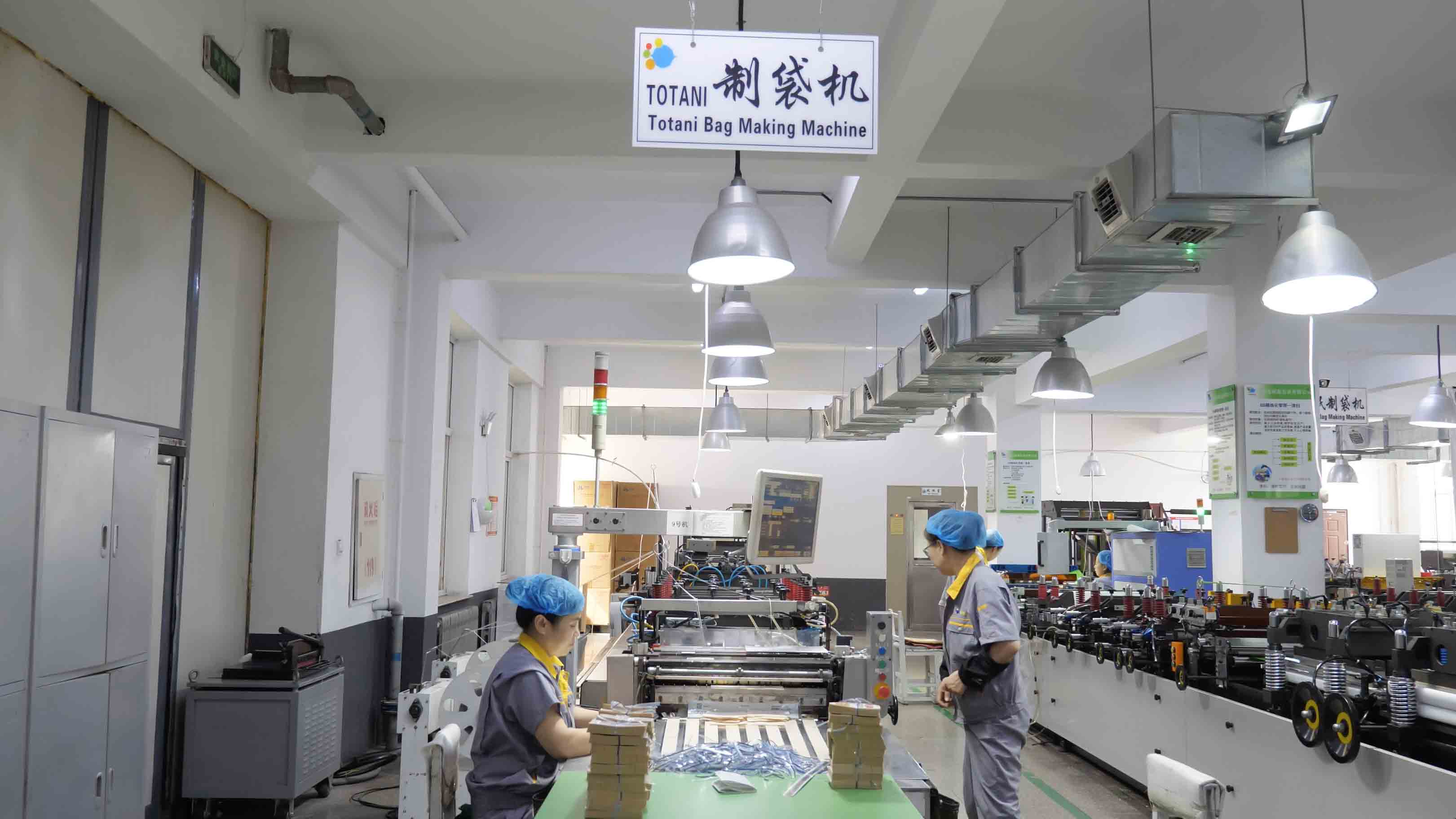 Team members working at a flexible packaging production line