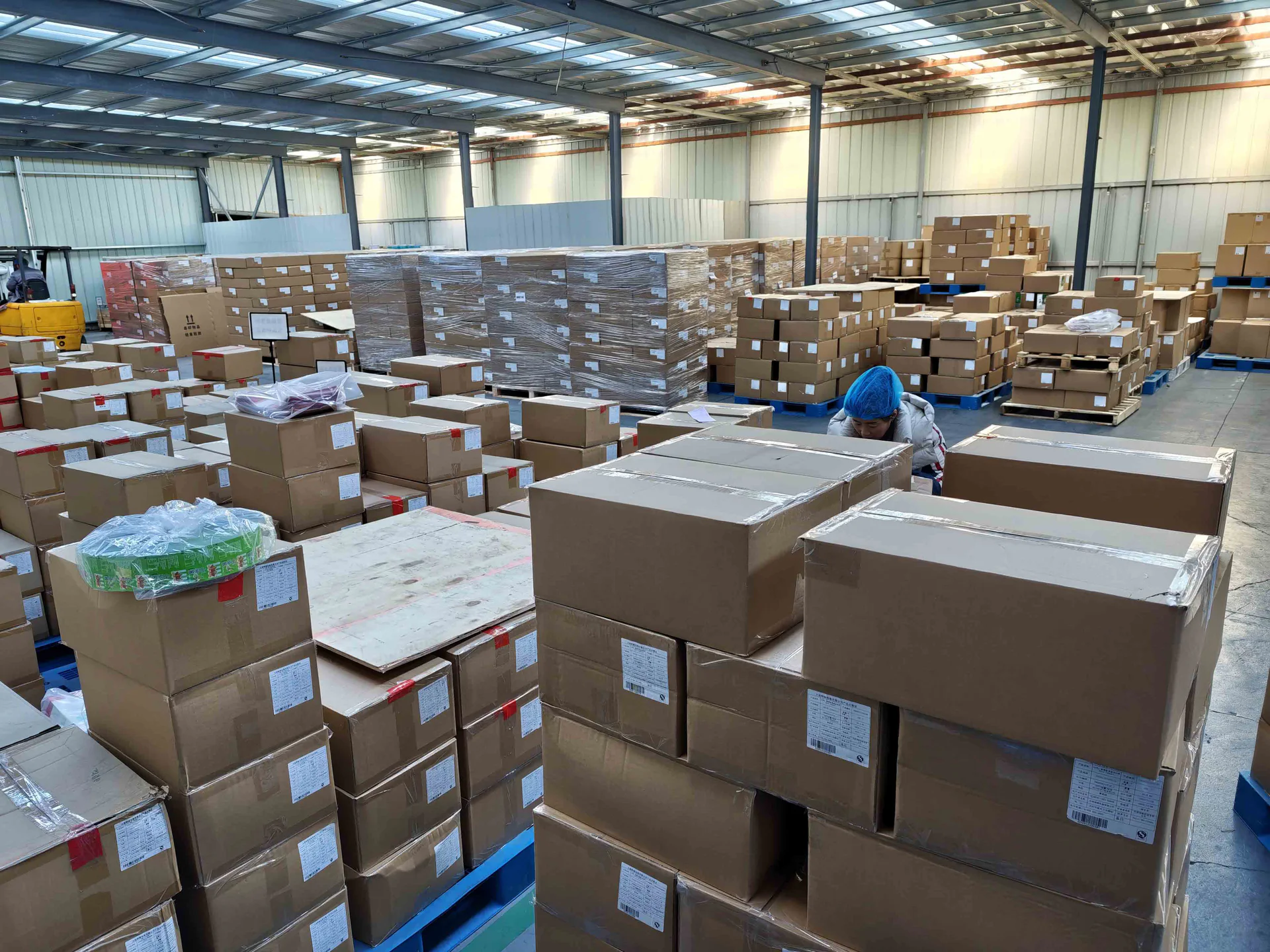 Finished cartons arranged on pallets in a packaging warehouse